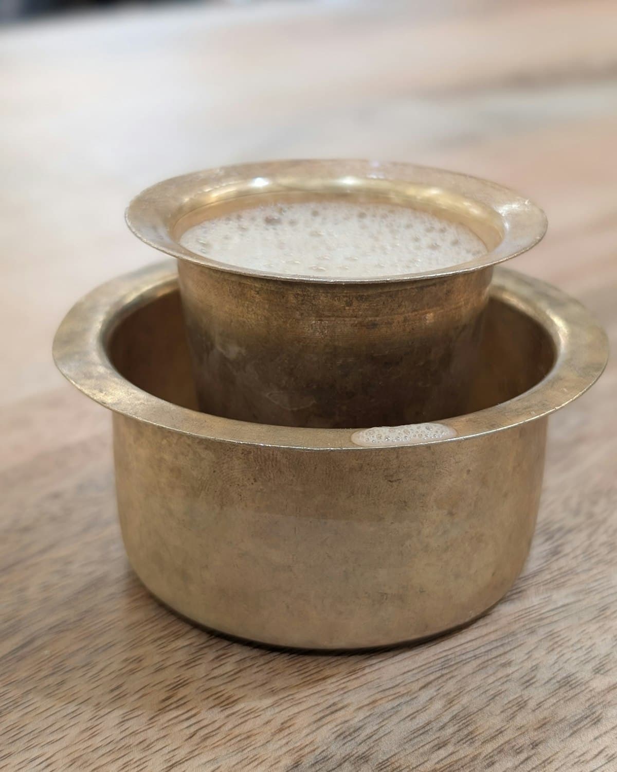 South Indian filter coffee in a brass tumbler and dabarah