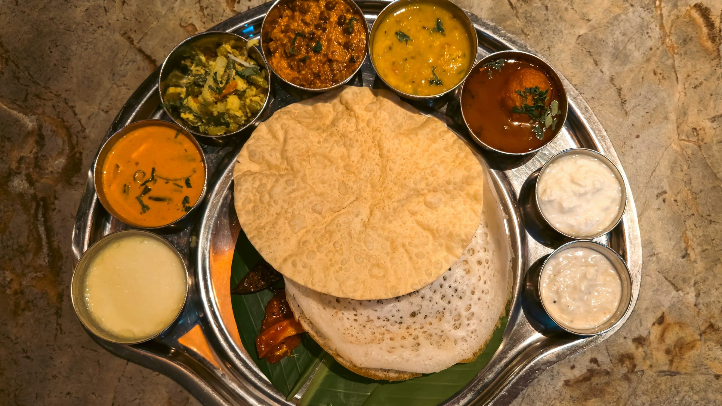 A table of Tamil dishes — dosa, biryani, curries and filter coffee